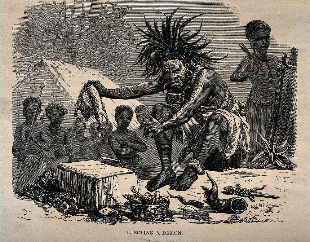 African medicine man exorcism. Wood engraving by Dalziel after J. Leech.